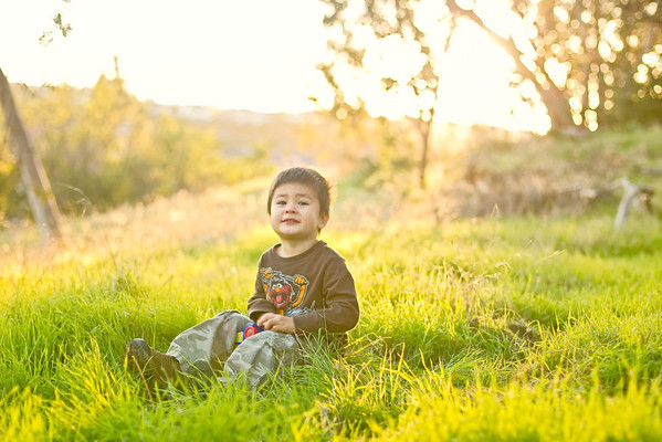 Child in grass at sunset